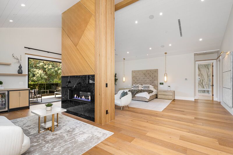 Interior design photography in Chevy Chase showcasing a bright and lively boho-inspired living room with abundant natural light, floating stairs, hanging plants, and a creative open layout perfect for plant lovers.
